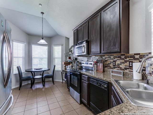 6211 Post Mi, San Antonio, TX 78244 - kitchen with appliances with stainless steel finishes, a sink, lofted ceiling, dark brown cabinets, and decorative backsplash