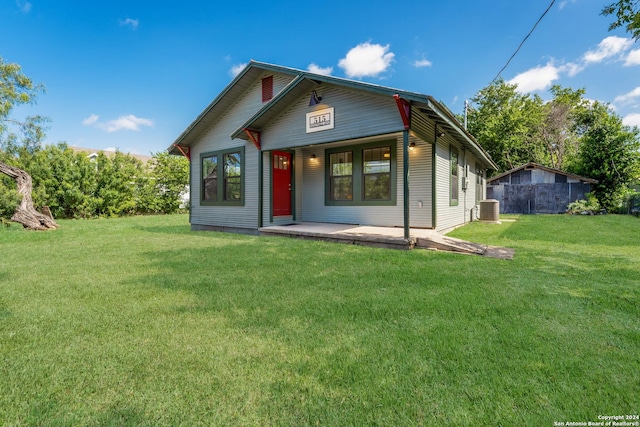 515 Westfall Ave, San Antonio, TX 78210 - view of front of home featuring a porch, a front lawn, and central AC