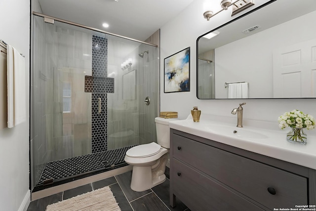 515 Westfall Ave, San Antonio, TX 78210 - bathroom featuring toilet, vanity, a shower stall, and tile patterned floors