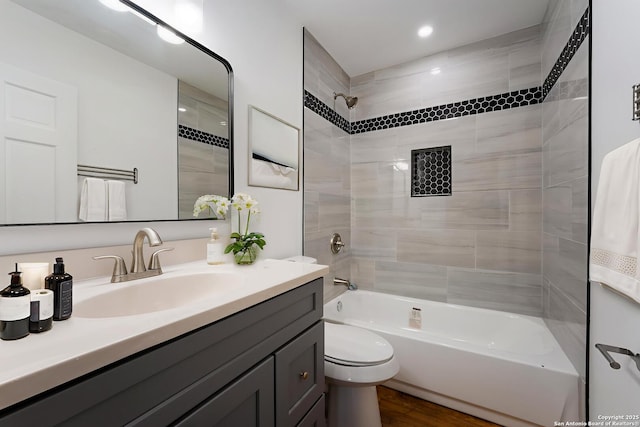 515 Westfall Ave, San Antonio, TX 78210 - bathroom with vanity, washtub / shower combination, toilet, recessed lighting, and wood finished floors