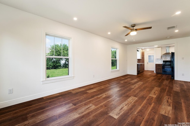 515 Westfall Ave, San Antonio, TX 78210 - unfurnished living room featuring dark wood-style floors, healthy amount of natural light, baseboards, a ceiling fan, and recessed lighting