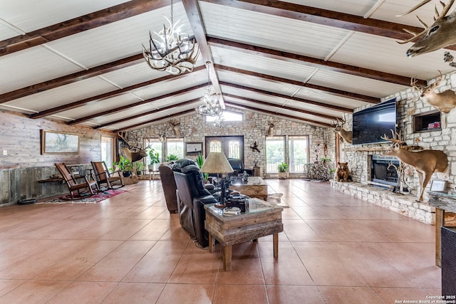 10745 Rosemar Ln, Adkins, TX 78101 - living area featuring a chandelier, a fireplace with raised hearth, tile patterned floors, and wooden walls