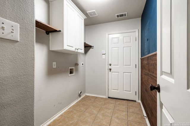 102 Blue Thorn, San Antonio, TX 78256 - laundry area with hookup for an electric dryer, cabinet space, light tile patterned floors, baseboards, and washer hookup