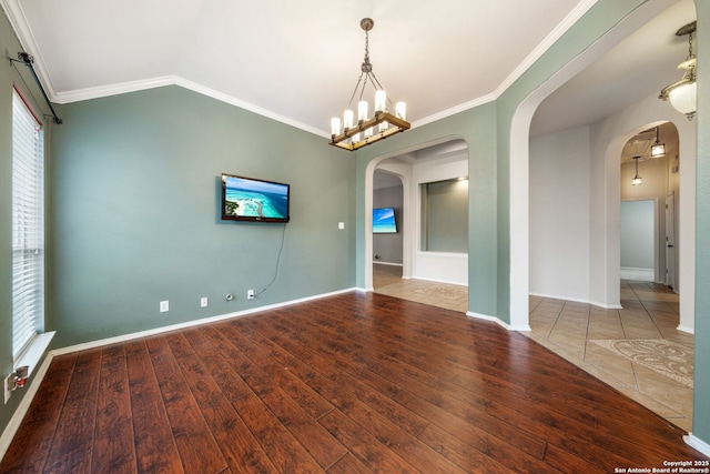 102 Blue Thorn, San Antonio, TX 78256 - spare room with arched walkways, wood finished floors, ornamental molding, baseboards, and a chandelier