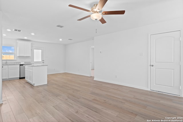 12055 Luckey Villa, San Antonio, TX 78252 - unfurnished living room featuring ceiling fan, light wood-style floors, recessed lighting, baseboards, and a sink