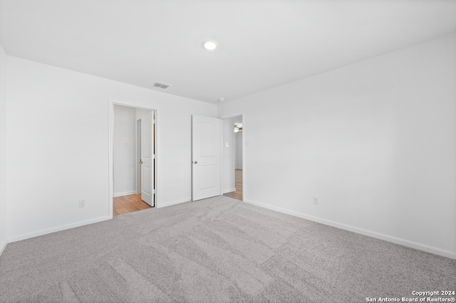 12055 Luckey Villa, San Antonio, TX 78252 - unfurnished bedroom featuring light carpet, baseboards, and recessed lighting