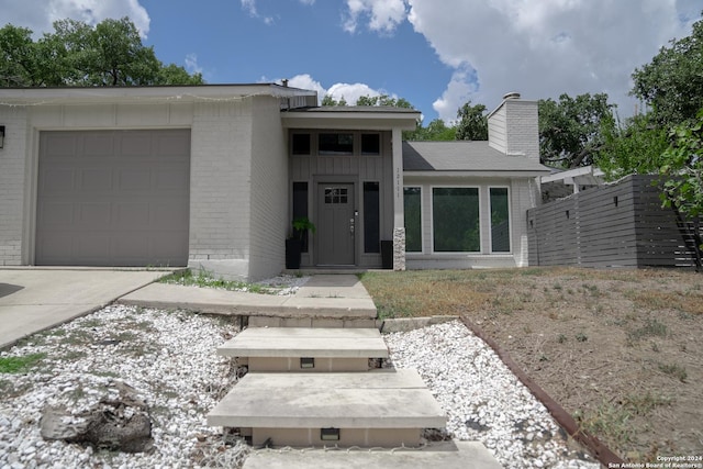 12111 Woodsrim, Live Oak, TX 78233 - view of front of property with brick siding, an attached garage, and driveway
