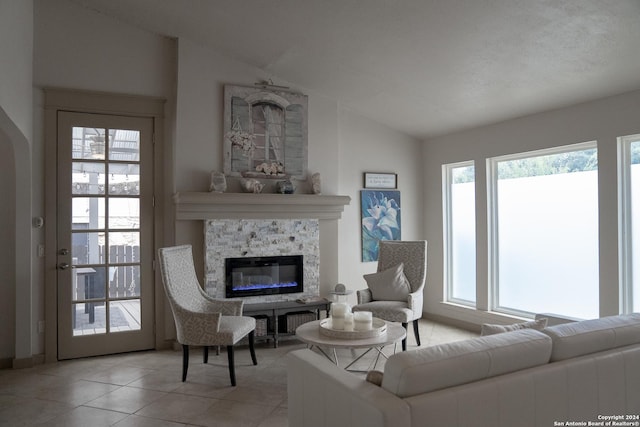 12111 Woodsrim, Live Oak, TX 78233 - living room with vaulted ceiling, light tile patterned flooring, and a stone fireplace