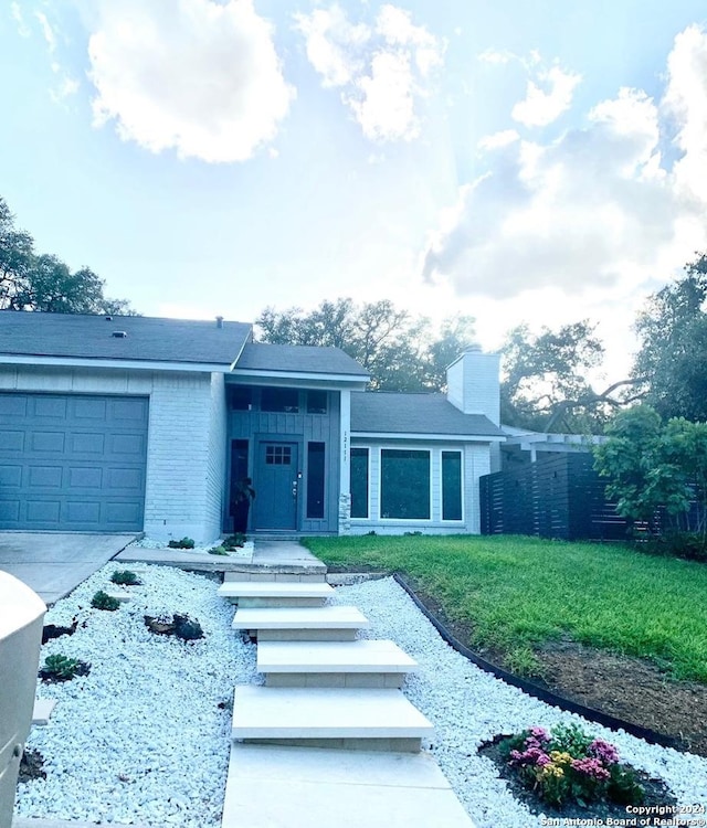 12111 Woodsrim, Live Oak, TX 78233 - view of front of house with an attached garage, brick siding, a chimney, and driveway