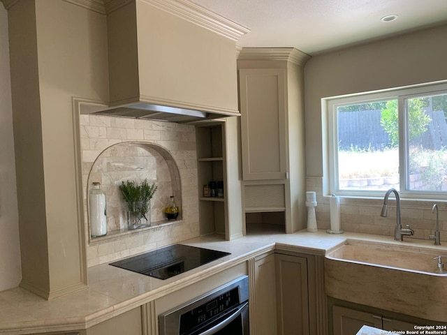 12111 Woodsrim, Live Oak, TX 78233 - kitchen featuring stainless steel oven, black electric stovetop, a sink, tasteful backsplash, and premium range hood