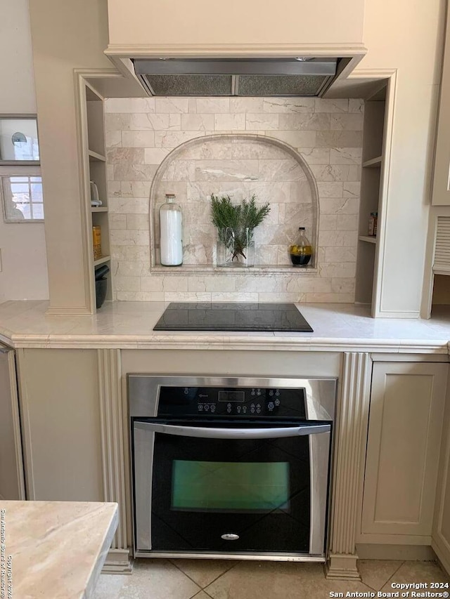 12111 Woodsrim, Live Oak, TX 78233 - kitchen view of oven, light countertops, black electric cooktop, and open shelves
