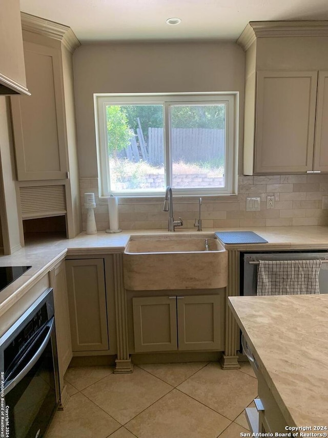 12111 Woodsrim, Live Oak, TX 78233 - kitchen with black oven, tasteful backsplash, light countertops, a sink, and light tile patterned floors