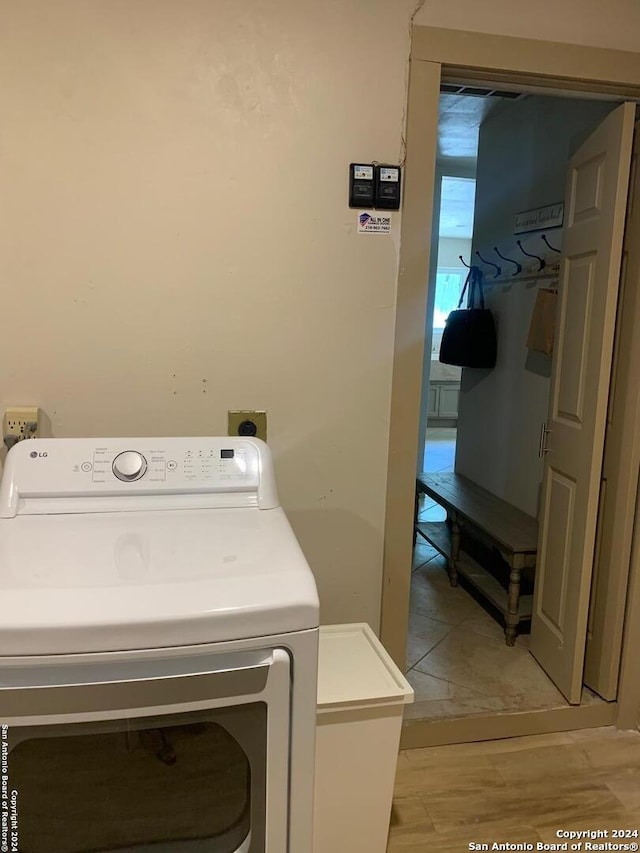 12111 Woodsrim, Live Oak, TX 78233 - washroom with washer / clothes dryer and light wood-type flooring