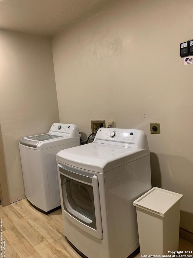 12111 Woodsrim, Live Oak, TX 78233 - laundry room with washer and dryer and light wood-style floors
