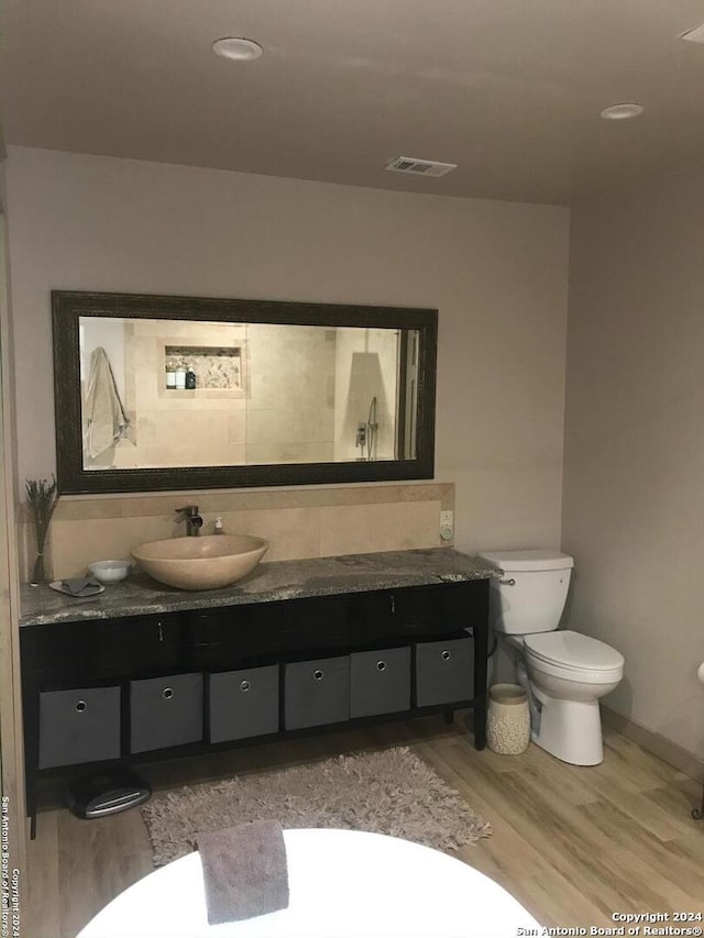 12111 Woodsrim, Live Oak, TX 78233 - bathroom with vanity, toilet, wood finished floors, and baseboards