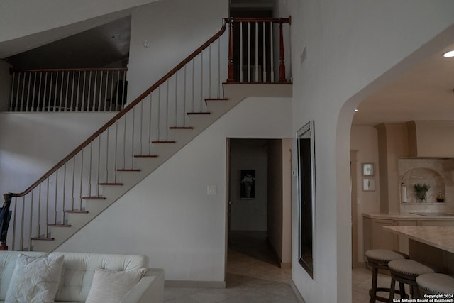 12111 Woodsrim, Live Oak, TX 78233 - staircase featuring arched walkways, a high ceiling, tile patterned floors, baseboards, and recessed lighting