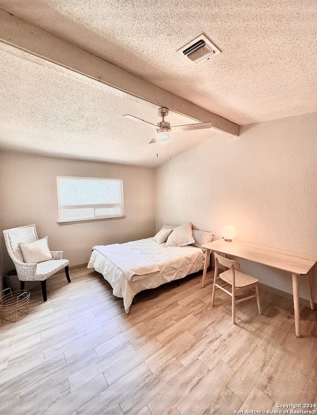 12111 Woodsrim, Live Oak, TX 78233 - bedroom featuring a textured ceiling, wood finished floors, and a ceiling fan