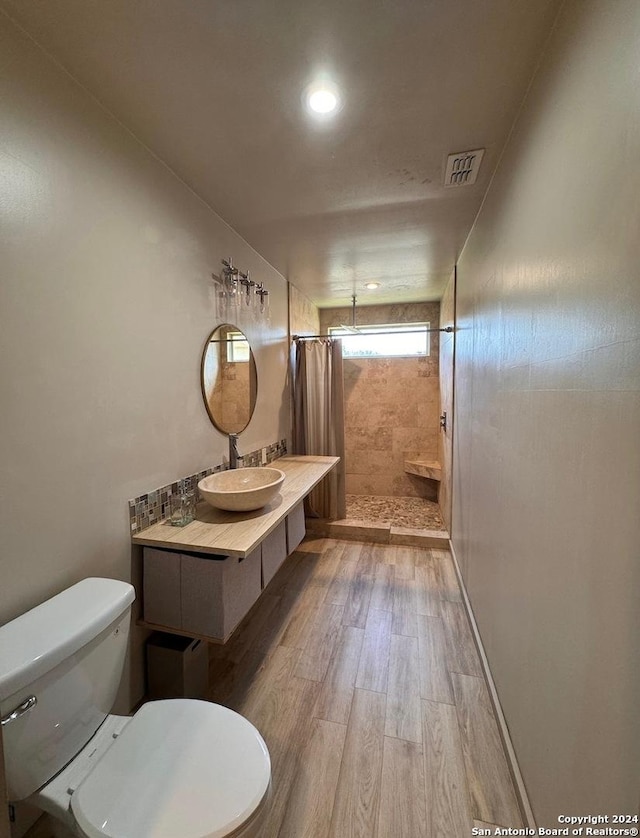 12111 Woodsrim, Live Oak, TX 78233 - full bathroom with toilet, wood finished floors, tiled shower, vanity, and recessed lighting