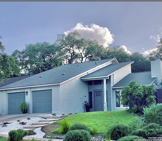 12111 Woodsrim, Live Oak, TX 78233 - view of front of house featuring an attached garage, driveway, brick siding, and a front yard