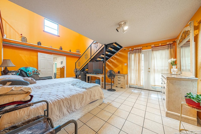 3211 Hatton, San Antonio, TX 78237 - bedroom featuring light tile patterned floors, access to outside, a textured ceiling, and french doors
