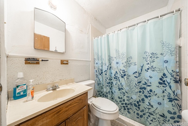 3211 Hatton, San Antonio, TX 78237 - bathroom with toilet, vanity, curtained shower, tile walls, and tile patterned flooring