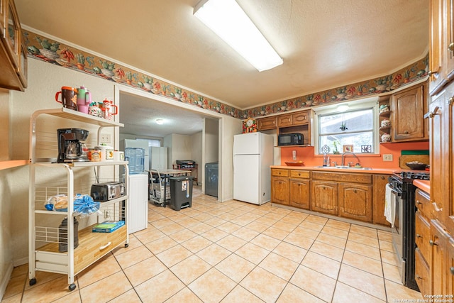 3211 Hatton, San Antonio, TX 78237 - kitchen featuring freestanding refrigerator, range with gas stovetop, black microwave, open shelves, and brown cabinetry