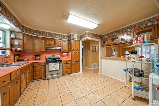 3211 Hatton, San Antonio, TX 78237 - kitchen with stainless steel range with gas cooktop, a sink, open shelves, brown cabinetry, and under cabinet range hood