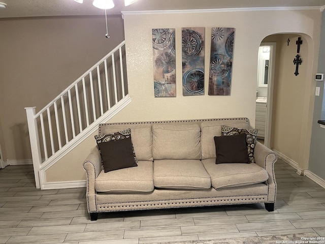 9858 Menard Cir, San Antonio, TX 78245 - living room with wood finish floors, stairway, arched walkways, and ornamental molding