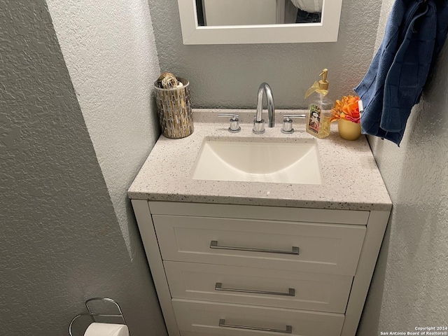 9858 Menard Cir, San Antonio, TX 78245 - bathroom with a textured wall and vanity