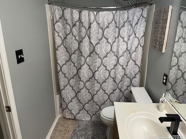 9858 Menard Cir, San Antonio, TX 78245 - full bath with vanity, curtained shower, a textured wall, and tile patterned flooring