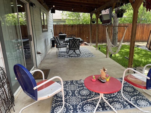 9858 Menard Cir, San Antonio, TX 78245 - fenced backyard featuring outdoor dining area and a patio