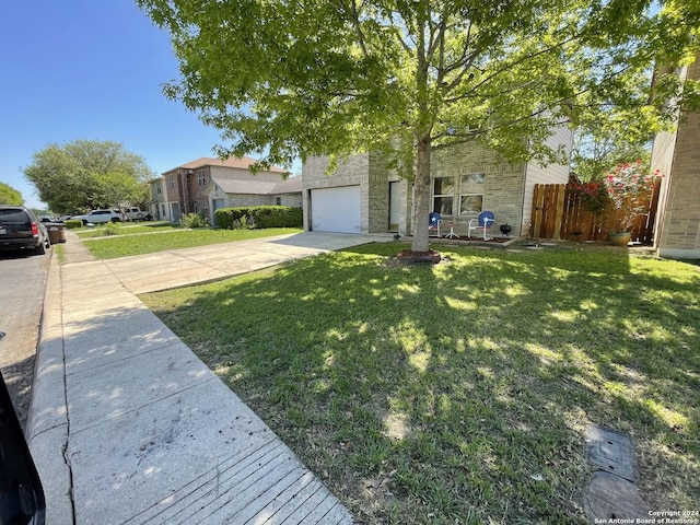 9858 Menard Cir, San Antonio, TX 78245 - view of front of home with concrete driveway, an attached garage, brick siding, and stone siding