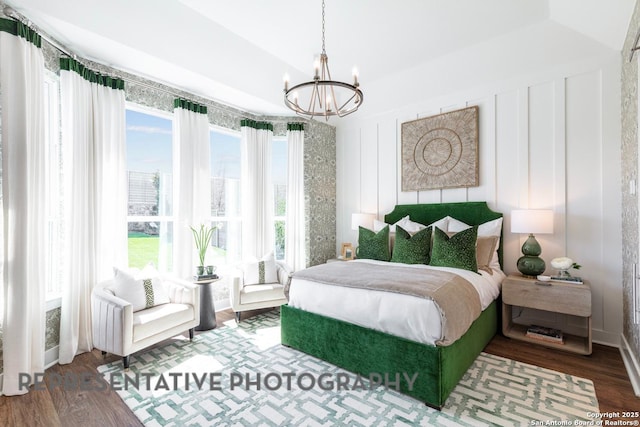 12376 Goulding, San Antonio, TX 78254 - bedroom with a chandelier, multiple windows, and wood finished floors