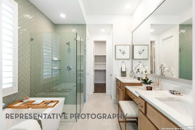 12376 Goulding, San Antonio, TX 78254 - full bath featuring two vanities, a stall shower, tile patterned floors, a freestanding tub, and tile walls
