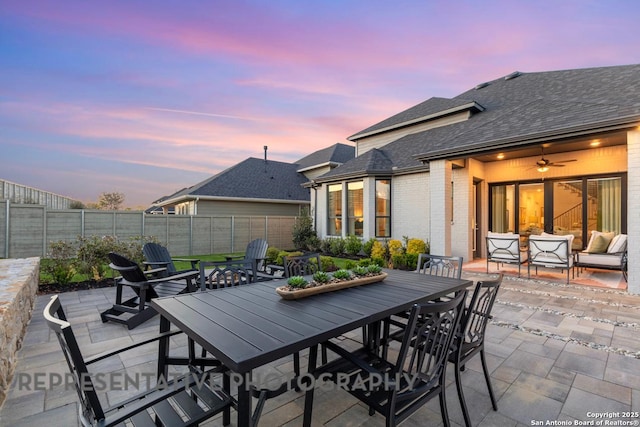 12376 Goulding, San Antonio, TX 78254 - patio terrace at dusk featuring a patio area, outdoor dining area, a fenced backyard, and outdoor lounge area