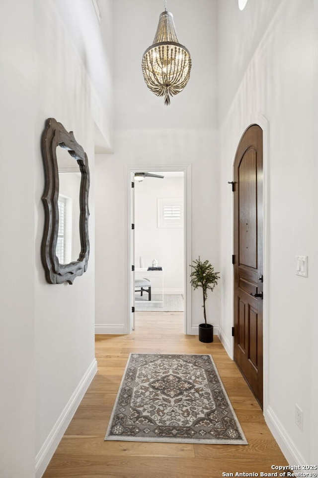 172 Katherine Ct Unit 1, San Antonio, TX 78209 - foyer entrance featuring a chandelier, light wood-type flooring, baseboards, and a high ceiling