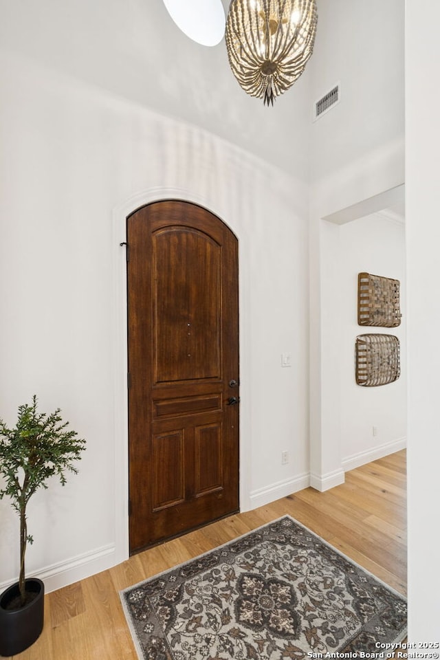 172 Katherine Ct Unit 1, San Antonio, TX 78209 - foyer featuring a chandelier, a high ceiling, wood finished floors, and baseboards