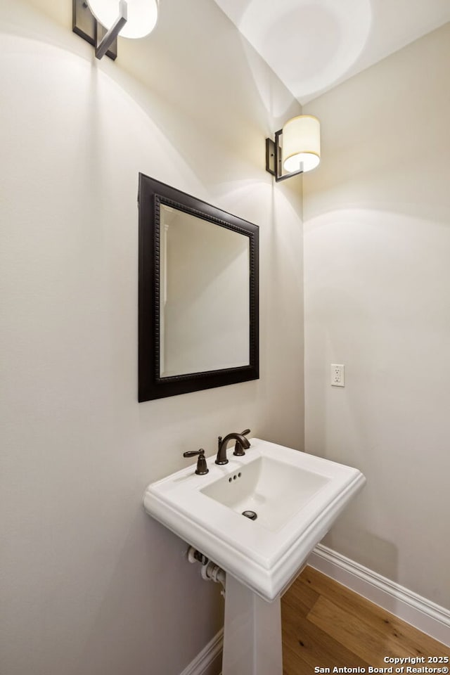 172 Katherine Ct Unit 1, San Antonio, TX 78209 - bathroom with baseboards, wood finished floors, and a sink