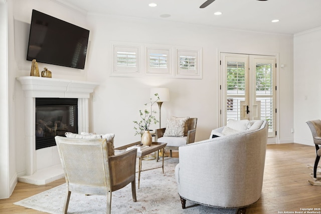 172 Katherine Ct Unit 1, San Antonio, TX 78209 - living area featuring crown molding, wood finished floors, a ceiling fan, a glass covered fireplace, and recessed lighting