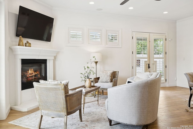 172 Katherine Ct Unit 1, San Antonio, TX 78209 - living room featuring ornamental molding, light wood-type flooring, ceiling fan, a glass covered fireplace, and recessed lighting