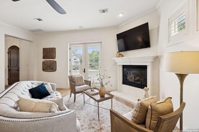 172 Katherine Ct Unit 1, San Antonio, TX 78209 - living room featuring ceiling fan, wood finished floors, crown molding, baseboards, and a fireplace with raised hearth