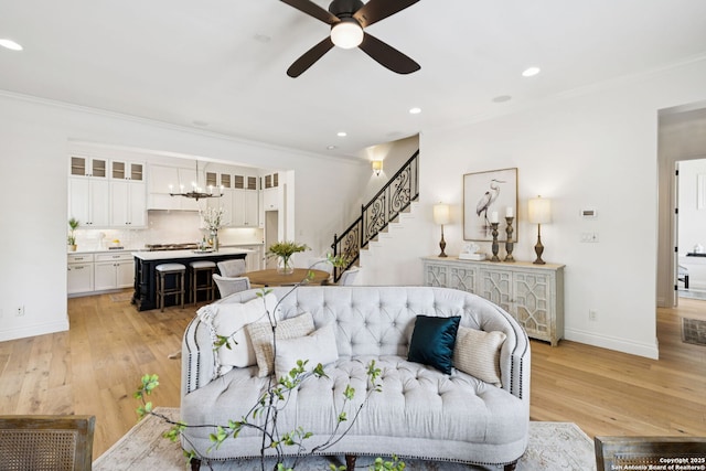 172 Katherine Ct Unit 1, San Antonio, TX 78209 - living area featuring a ceiling fan, crown molding, light wood-style floors, baseboards, and stairway