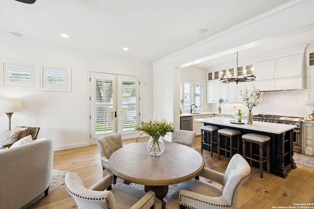 172 Katherine Ct Unit 1, San Antonio, TX 78209 - dining room with ornamental molding, a chandelier, healthy amount of natural light, light wood-style floors, and recessed lighting