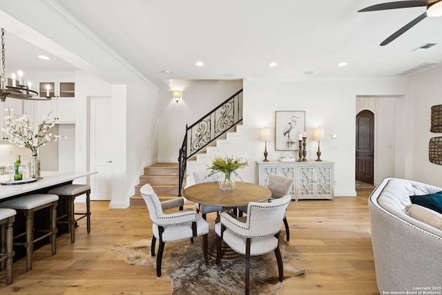 172 Katherine Ct Unit 1, San Antonio, TX 78209 - dining space with stairs, light wood-style floors, ceiling fan, crown molding, and a chandelier