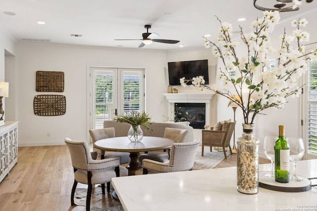 172 Katherine Ct Unit 1, San Antonio, TX 78209 - dining space featuring a glass covered fireplace, ceiling fan, crown molding, light wood finished floors, and recessed lighting