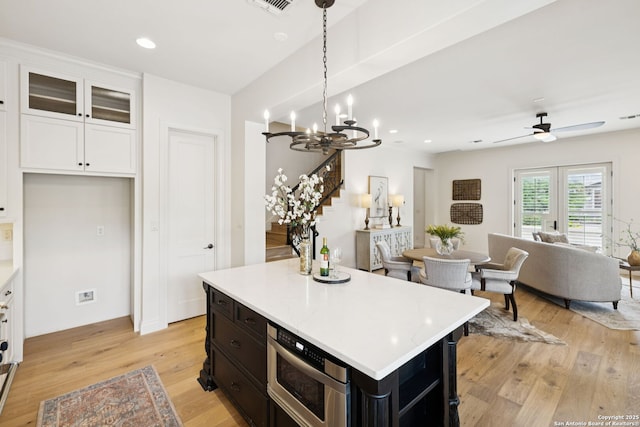 172 Katherine Ct Unit 1, San Antonio, TX 78209 - kitchen featuring open floor plan, white cabinets, light wood-style floors, light countertops, and recessed lighting