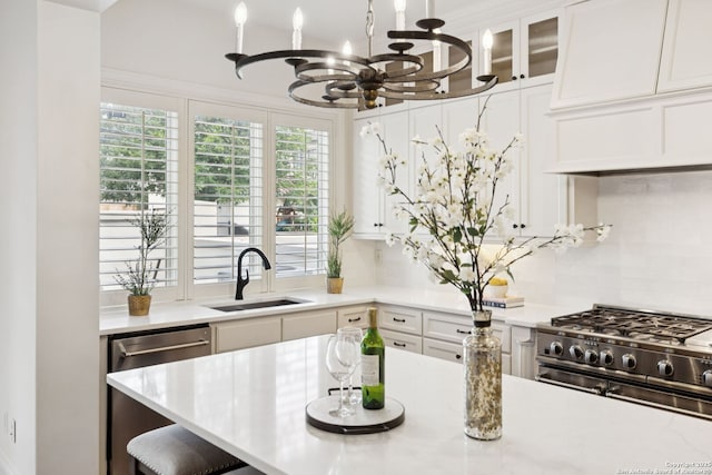 172 Katherine Ct Unit 1, San Antonio, TX 78209 - kitchen featuring a sink, a chandelier, appliances with stainless steel finishes, light countertops, and tasteful backsplash