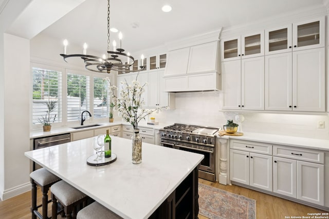 172 Katherine Ct Unit 1, San Antonio, TX 78209 - kitchen with appliances with stainless steel finishes, custom exhaust hood, a chandelier, light countertops, and a sink