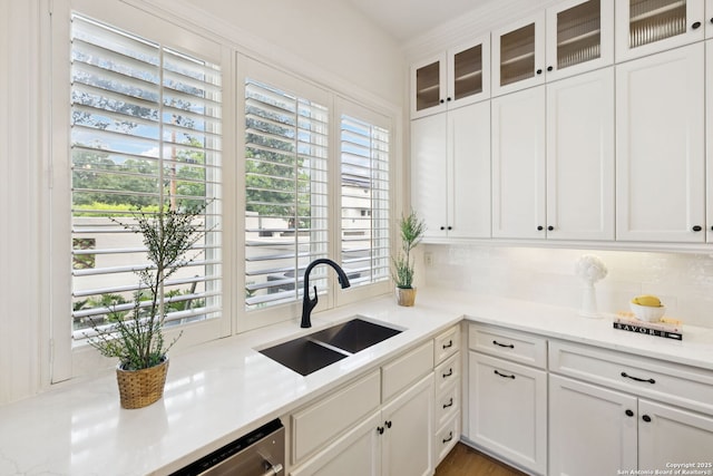 172 Katherine Ct Unit 1, San Antonio, TX 78209 - kitchen featuring a sink, healthy amount of natural light, decorative backsplash, and white cabinets