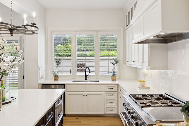 172 Katherine Ct Unit 1, San Antonio, TX 78209 - kitchen featuring double oven range, a sink, custom exhaust hood, a chandelier, and light countertops